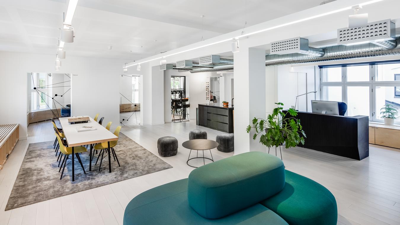 Reception with seating areas and kitchen. Photo