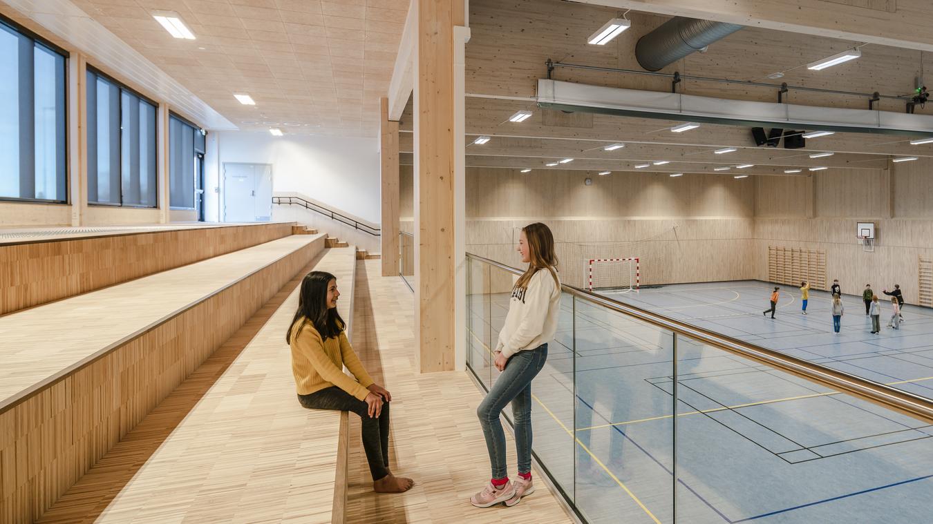 Gymnasium, interior with exposed solid wood and blue floor. Photo